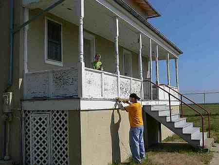 Ryan scrapes the porch.